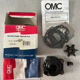 OMC water pump repair kit components on a gray surface