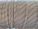 Close-up of a spool of white rope with red stitching on a blurred background